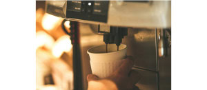 Bean-to-cup commercial coffee machine dispensing coffee