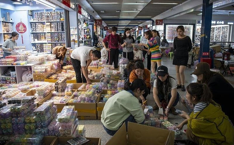 Bulk-packed stock of fashion jewelry cartons inside a Yiwu jewelry market booth