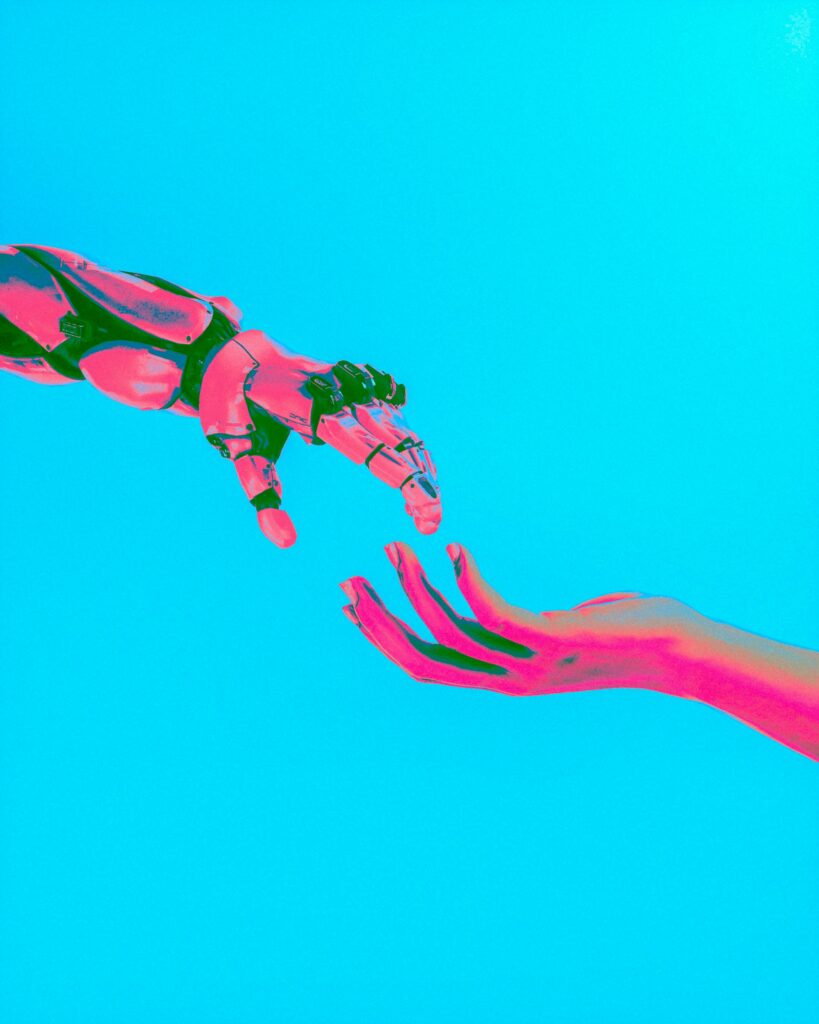 AI in HR symbolized by a robot am and a human arm touching