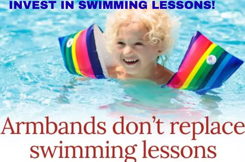 A child wearing orange armbands in a swimming pool, illustrating why armbands should not replace formal swimming lessons.