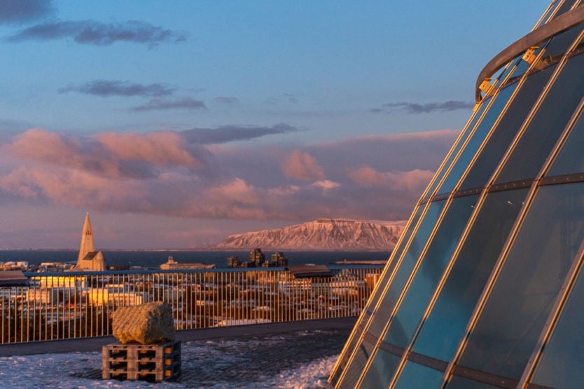 Some of the dome of the Perlan Museum with Hallgrimskirkja Church and Esja in the distance