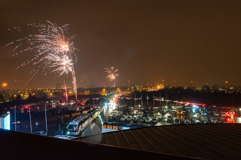 parking lot at perlan on new year's eve with fireworks