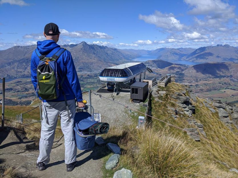 holding picnic basket at coronet peak near queenstown