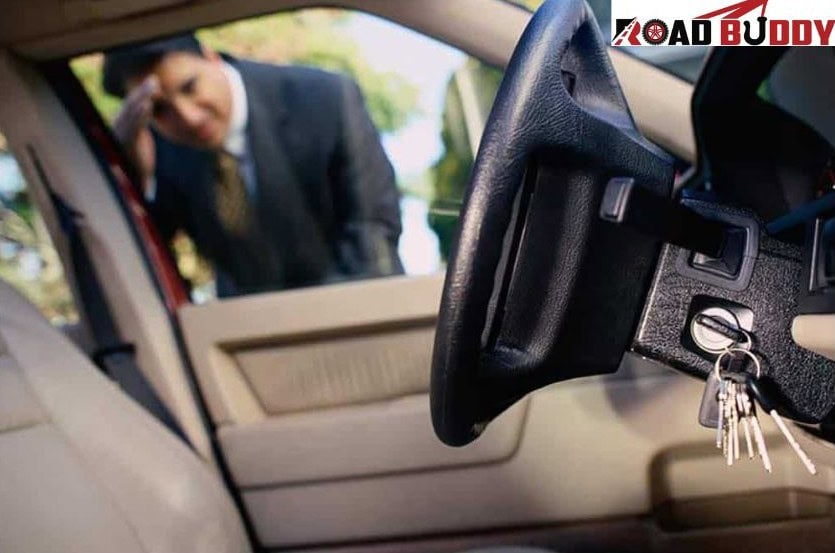 Automotive locksmith programming and replacing car keys near vehicle at roadside