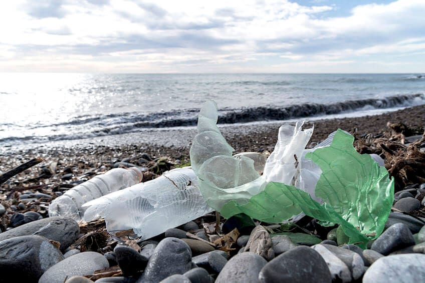 Compostable Plastic by Adria Vasil | An image of plastic waste on a beach
