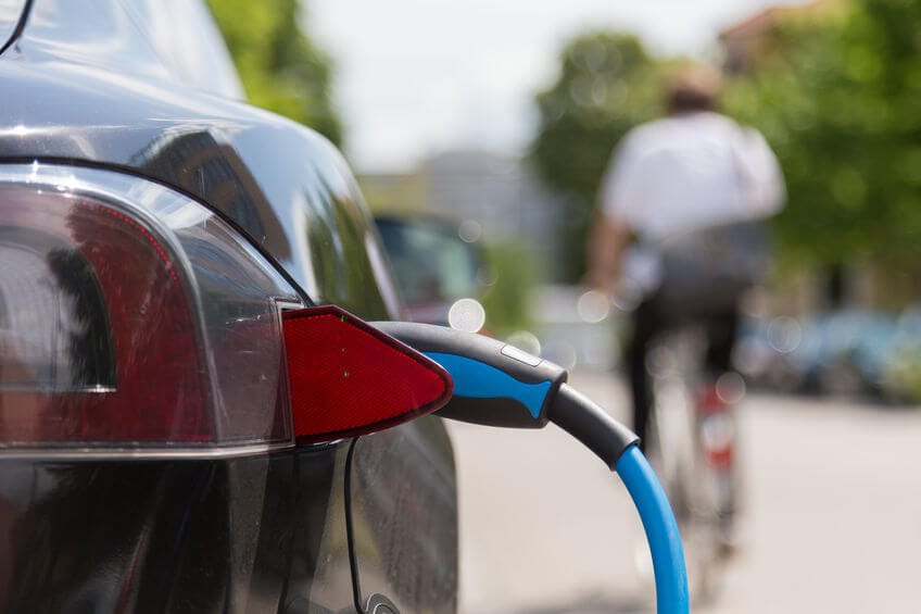 Power supply plugged into an electric car being charged.