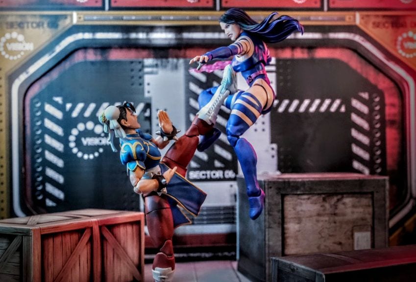 Psylocke Marvel Legends figure mid-air kicking Chun-Li action figure in a futuristic diorama battle scene
