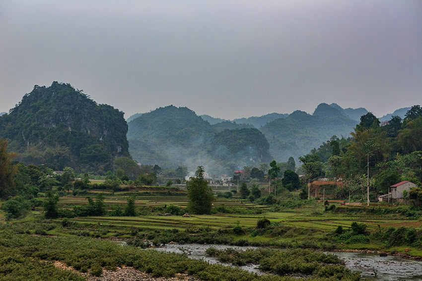 River, rice fields, mountains and a few houses