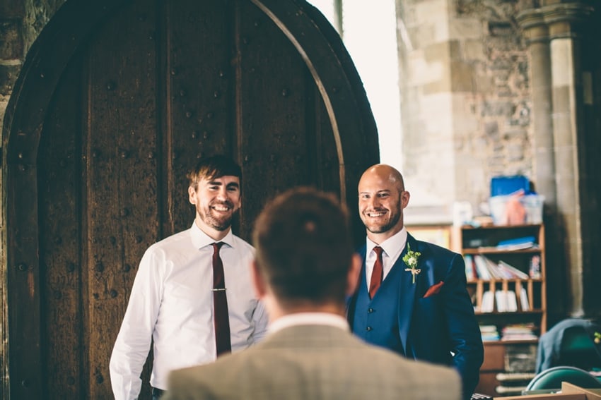 Groom greeting wedding guests