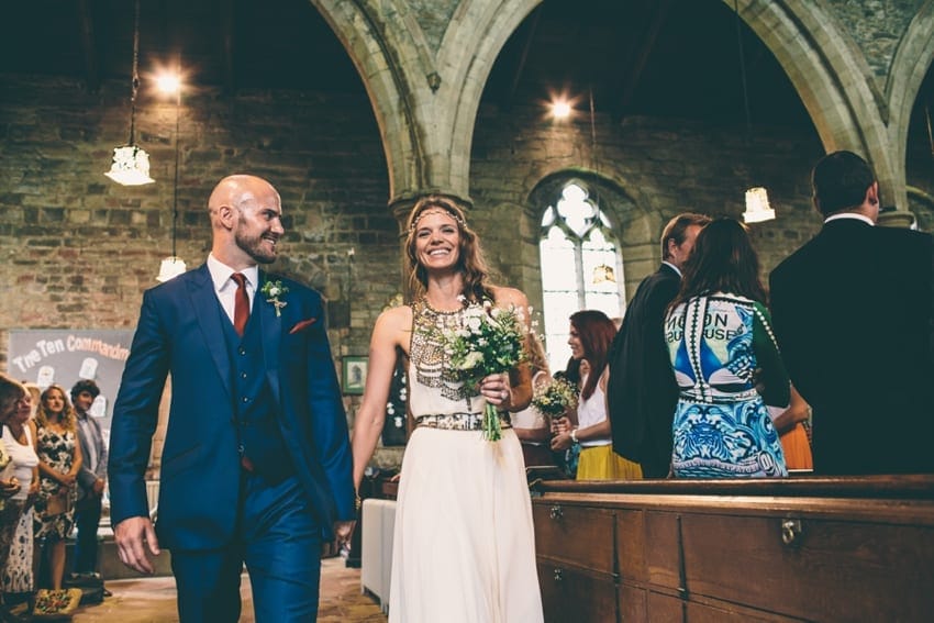 Bride and groom walking out of church