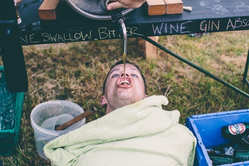 Keg of beer being consumed by wedding guest