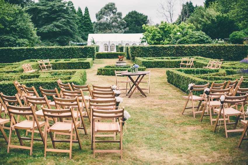 wooden ceremony chairs in garden