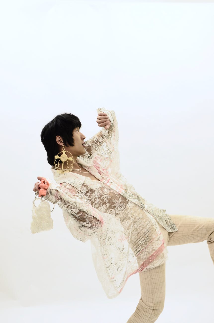 stylish ethnic man dancing in studio