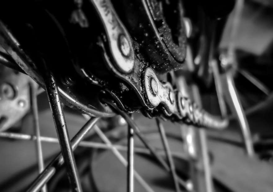 Closeup image of a greasy bicycle chain