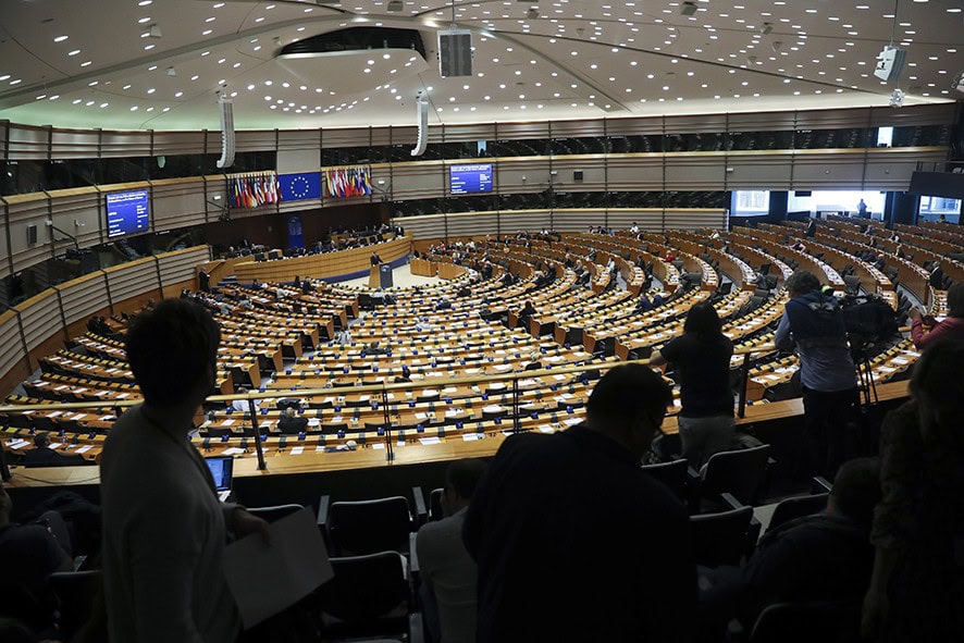 Sweden's Prime Minister Stefan Lofven, background center, addresses European Parliament members at the main chamber of the European Parliament in Brussels, Wednesday, April 3, 2019. (AP Photo/Francisco Seco)