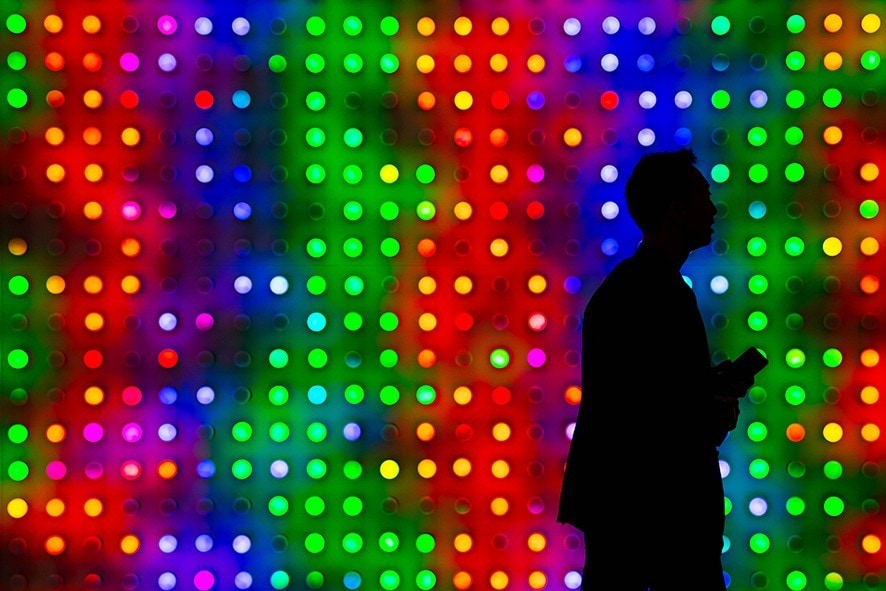 BARCELONA, SPAIN - FEBRUARY 26: A visitor walks holding his mobile phone at the Xiaomi booth on day 2 of the GSMA Mobile World Congress 2019 on February 26, 2019 in Barcelona, Spain. The annual Mobile World Congress hosts some of the world's largest communications companies, with many unveiling their latest phones and wearables gadgets like foldable screens and the introduction of the 5G wireless networks. (Photo by David Ramos/Getty Images)