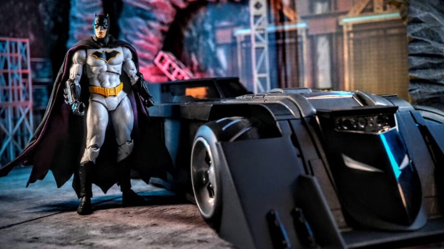 DC Multiverse Rebirth Batman standing next to Batmobile in Batcave diorama.