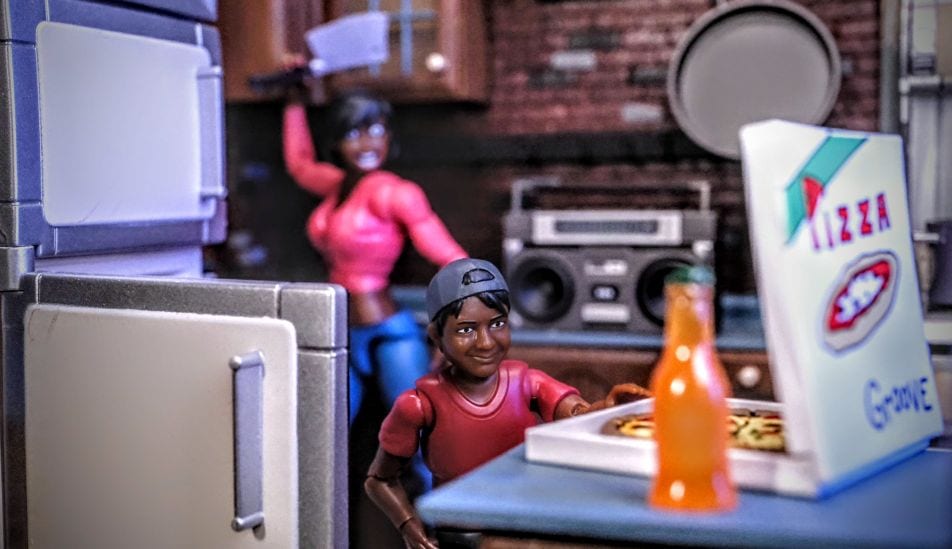 Figures Toy Company Ultimate Wrestling Fan Ethan figure reaching for pizza while Tasha raises a meat cleaver in a kitchen diorama