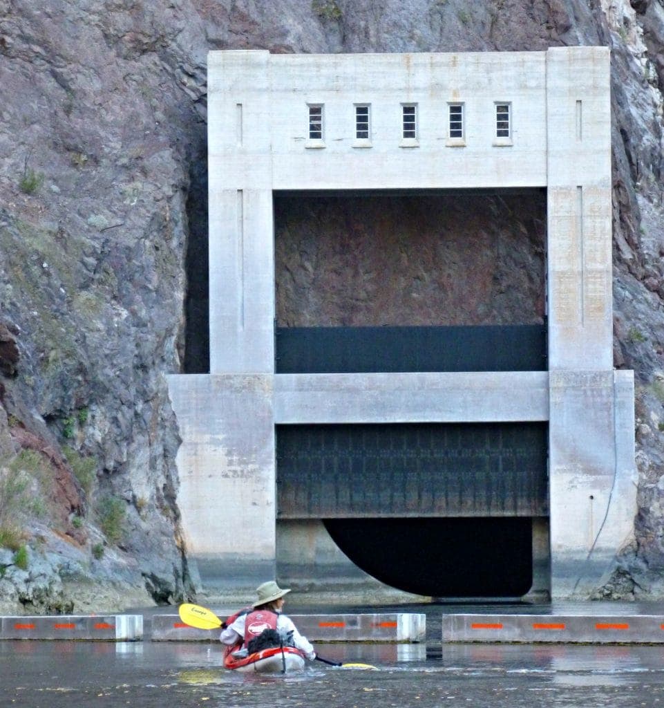 Unstoppable Stacey looks tiny against the dam as she paddles on her Hoover Dam kayak tour