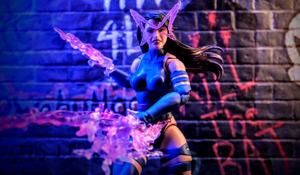 Marvel Legends Psylocke action figure with butterfly psychic energy effect posed in front of graffiti brick wall