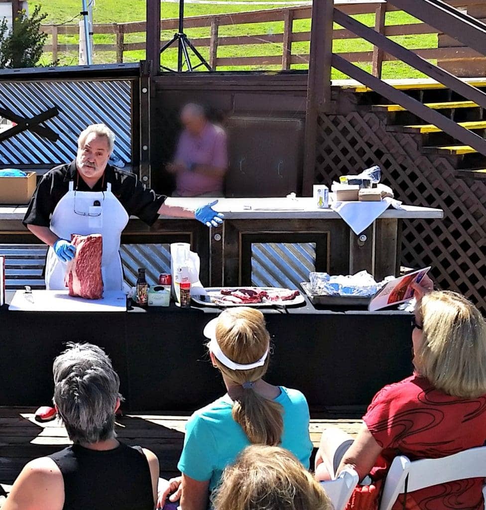 Meathead Goldwyn holds Texas Waygu Beef in front of outdoor audience