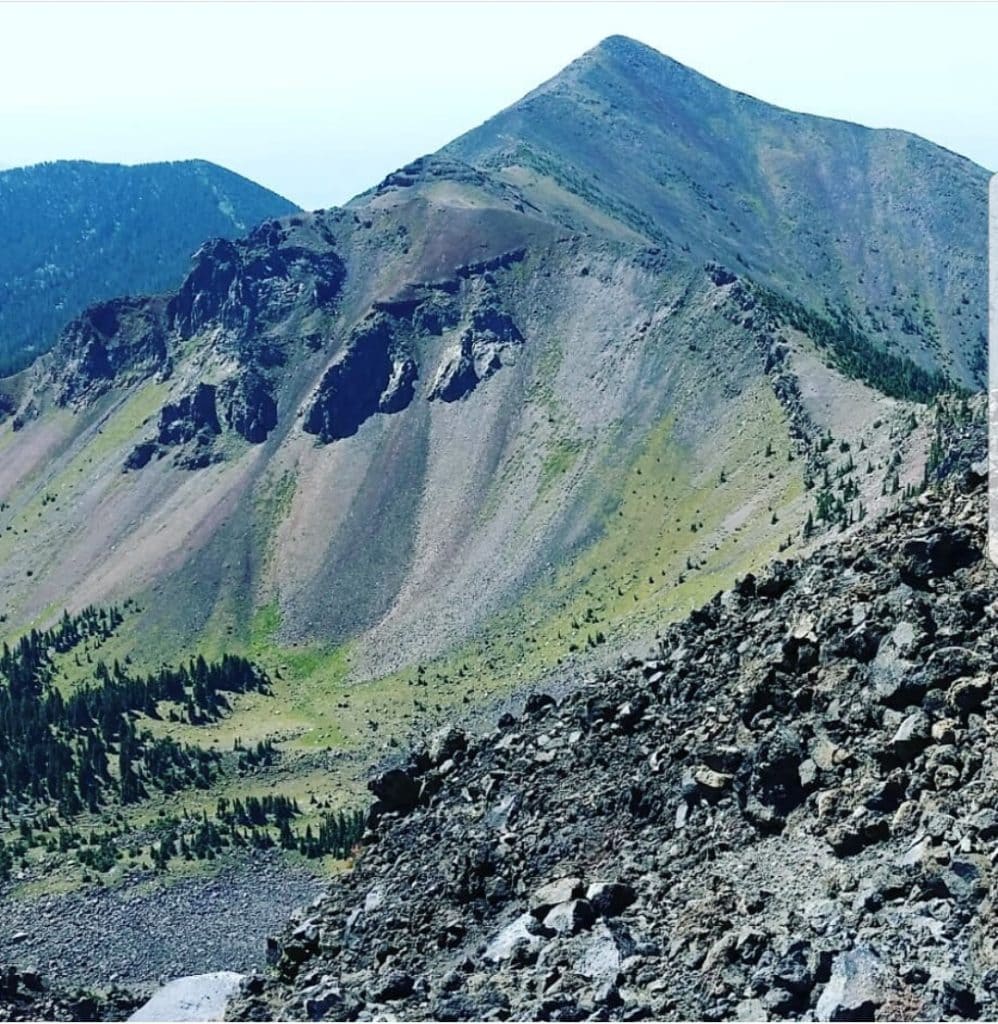 Sharp mountain peak looms ahead from a rocky trail