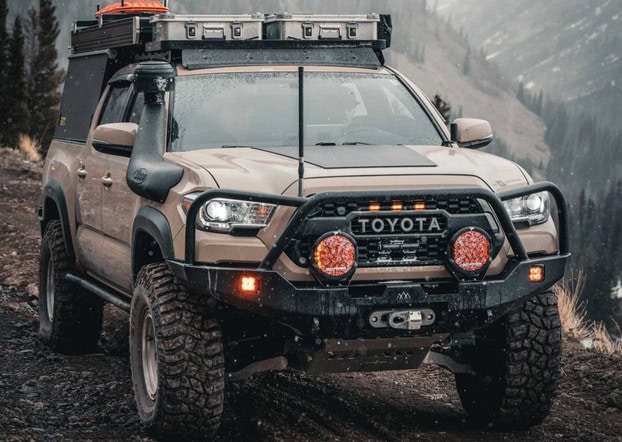 Backwoods Adventure Mods high-clearance front bumper on desert sand Tacoma