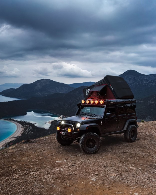 Jeep Wrangler with an iKamper rooftop tent overlooking ocean