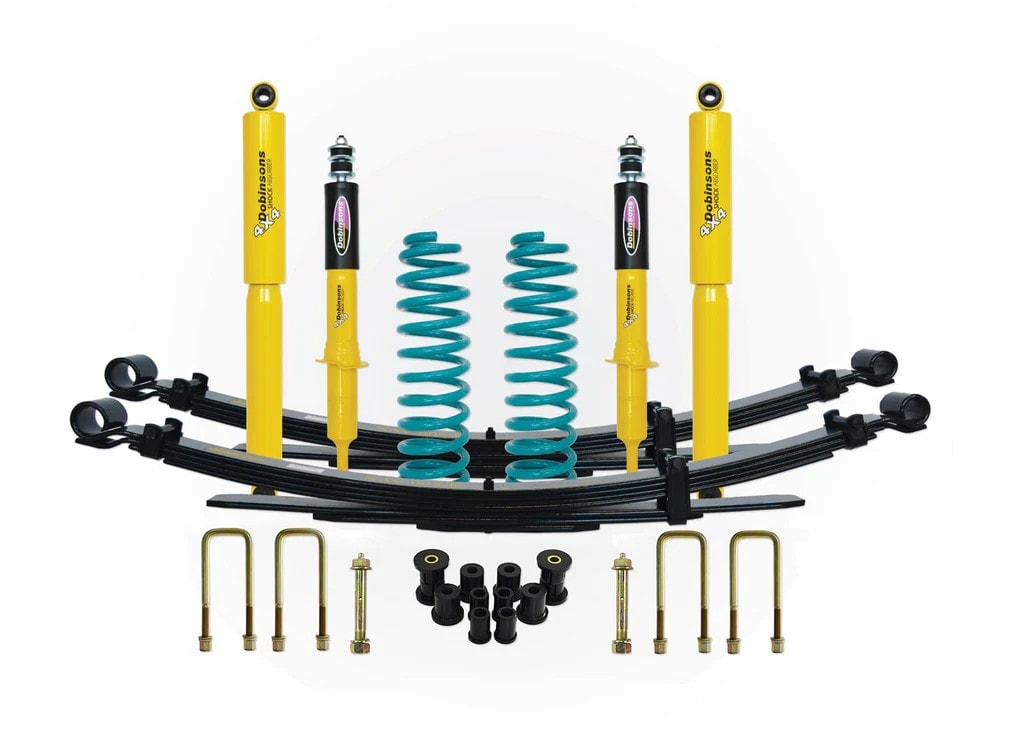 Turqoise front coil springs, yellow front struts, rear leaf springs, rear shocks, leaf spring bushings, U-bolts, and greasable pins are all spaced evenly facing upward on a white background.