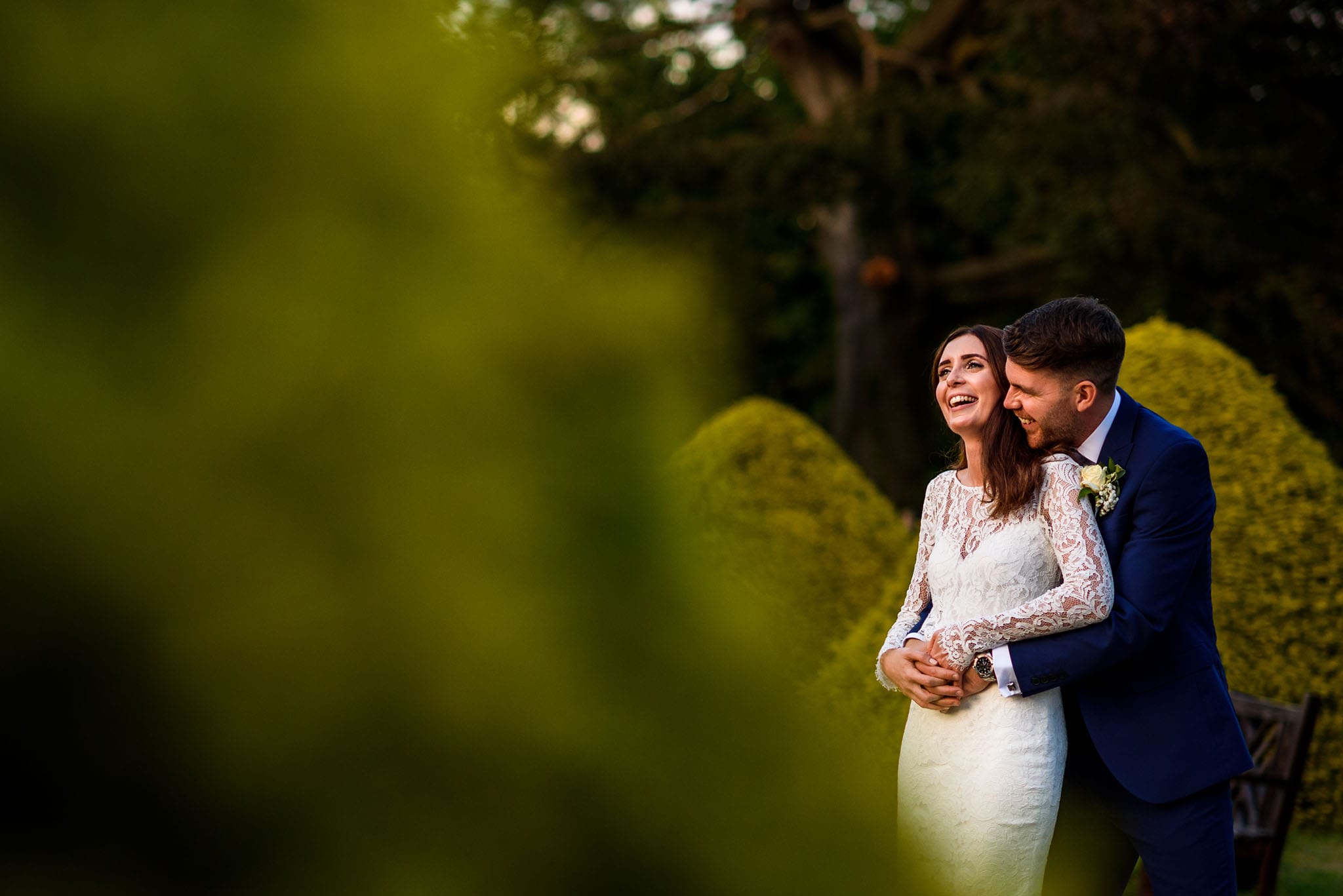 early evening portrait of the bride and groom laughing together