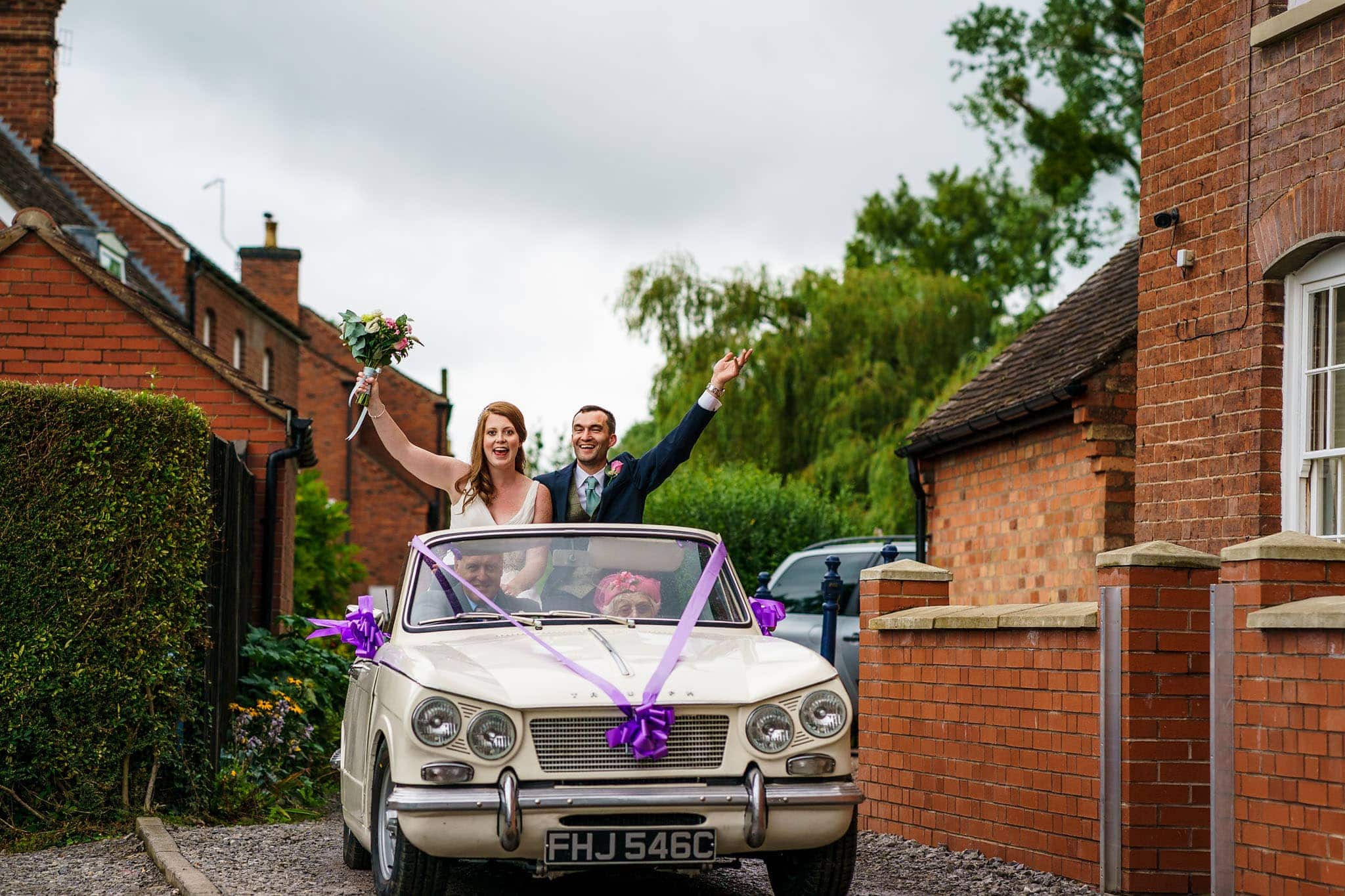 bride and groom arrival in vintage car