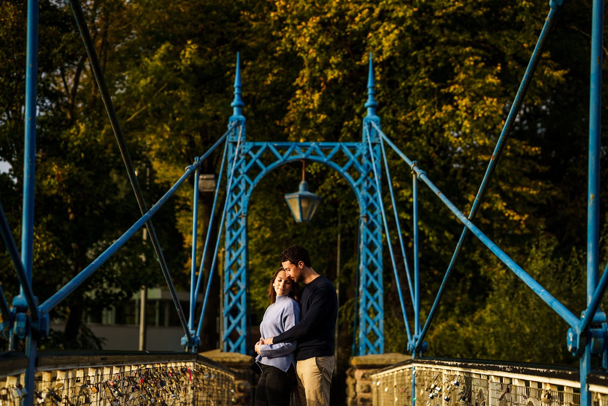 portrait of a couple on the suspension bridge at Jephson Gardens