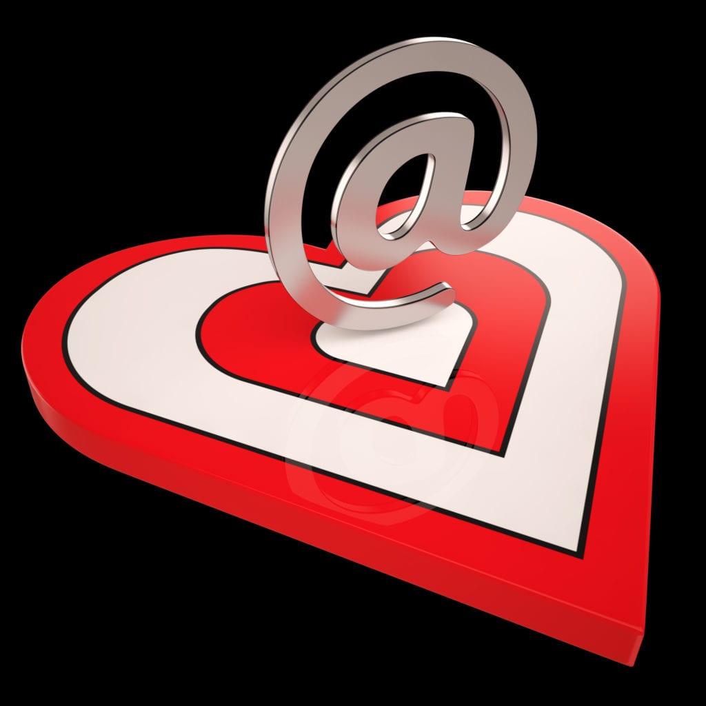 Red and white heart with silver @ symbol on black background, representing sending romantic emails on ChristianDatingInternational.com.
