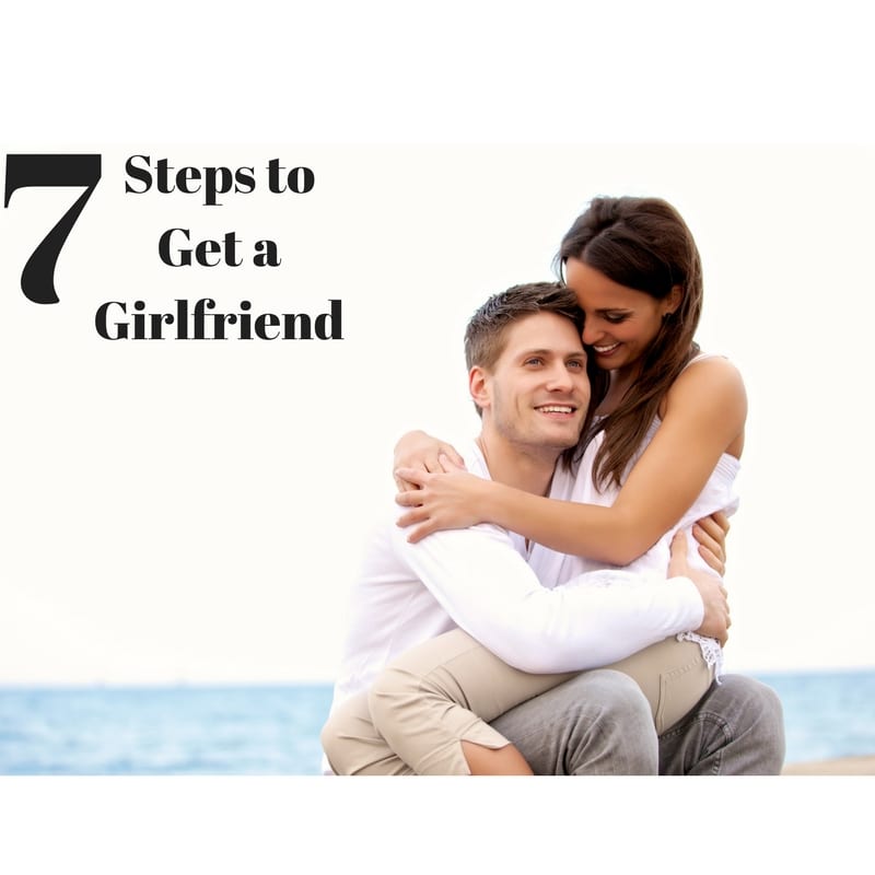 Couple on a beach, with the woman sitting on the man's lap, symbolizing romantic connection and the steps to forming a lasting relationship.