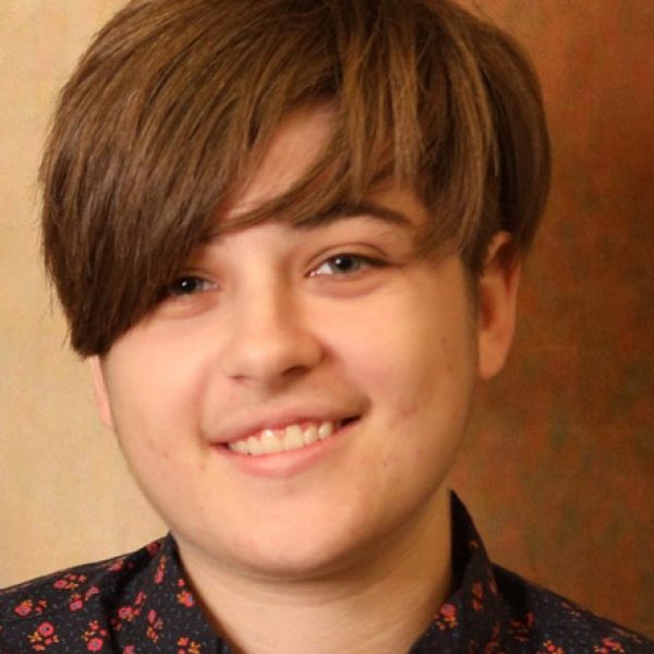 A student looking and smiles