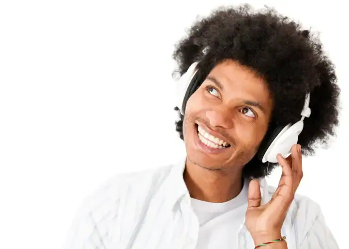 Thoughtful man listening to music - isolated over a white background