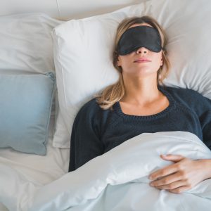 Woman sleeping with sleep mask.