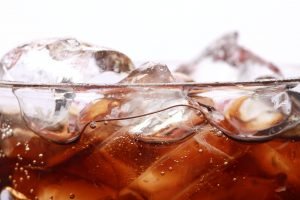 Coke in a glass with ice cubes isolated on a white background
