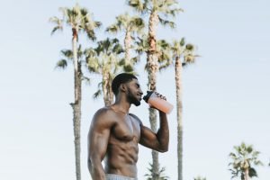 Muscular man drinking a protein shake