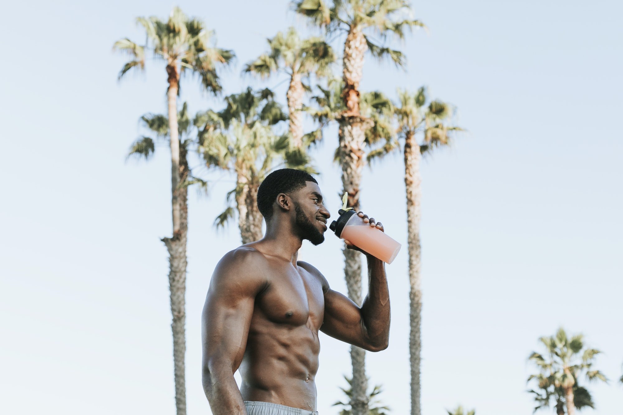 Muscular man drinking a protein shake