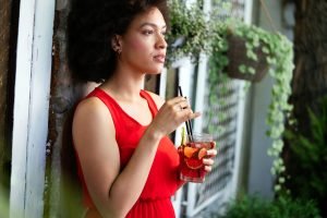 Young african woman enjoy healthy vegetarian smoothie for weight loss