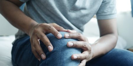 Close up on man suffering knee joint pain