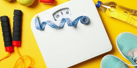 Weight loss or healthy lifestyle accessories on yellow background