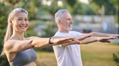 A mature couple exercising in the park