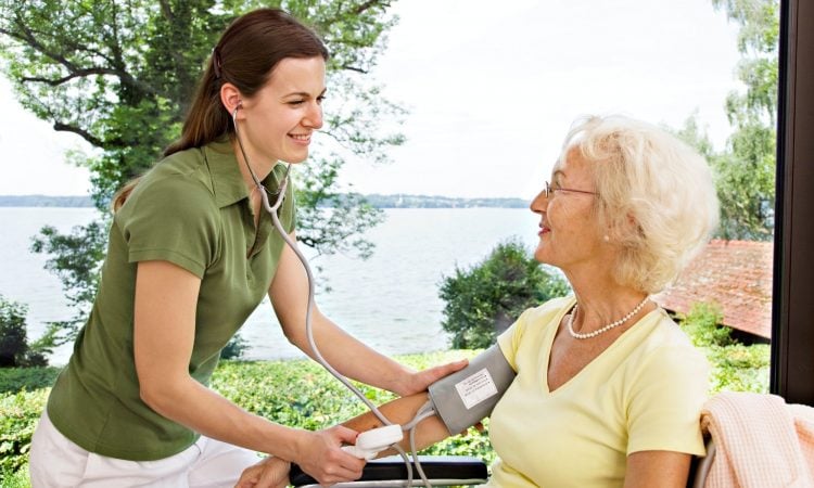 nurse taking woman's blood pressure