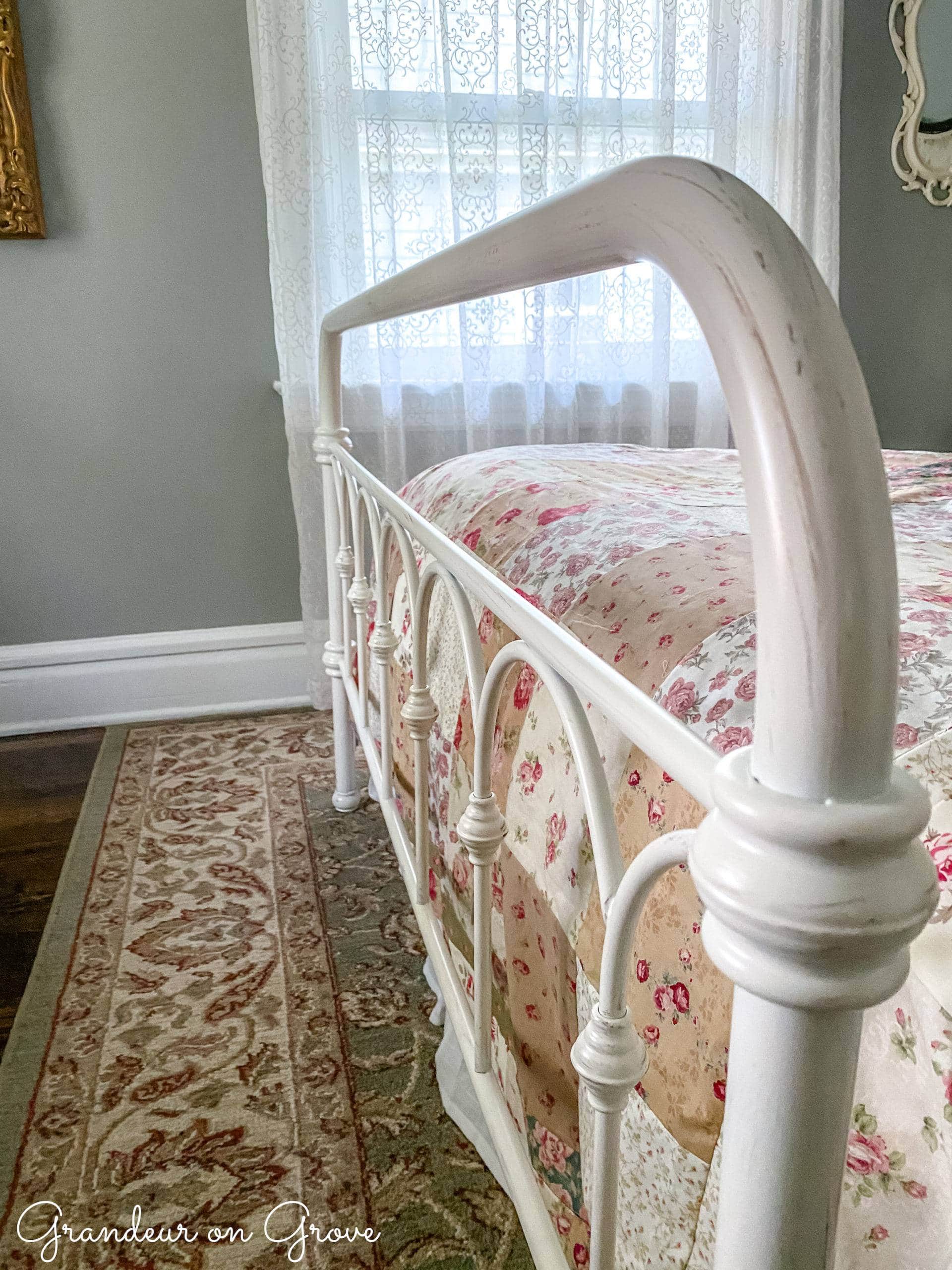 metal bed footboard with rose quilt