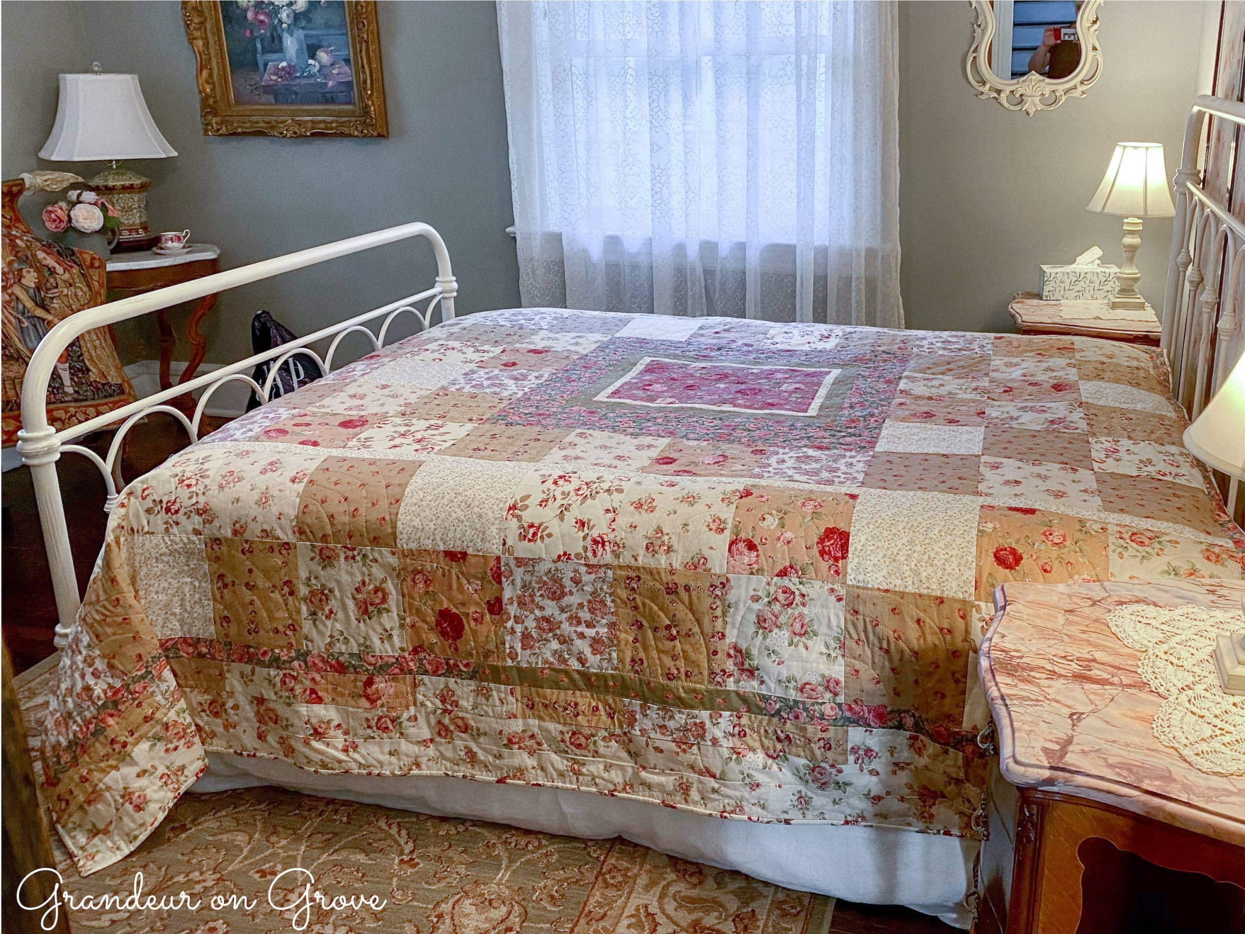 A floral quilt on a queen bed