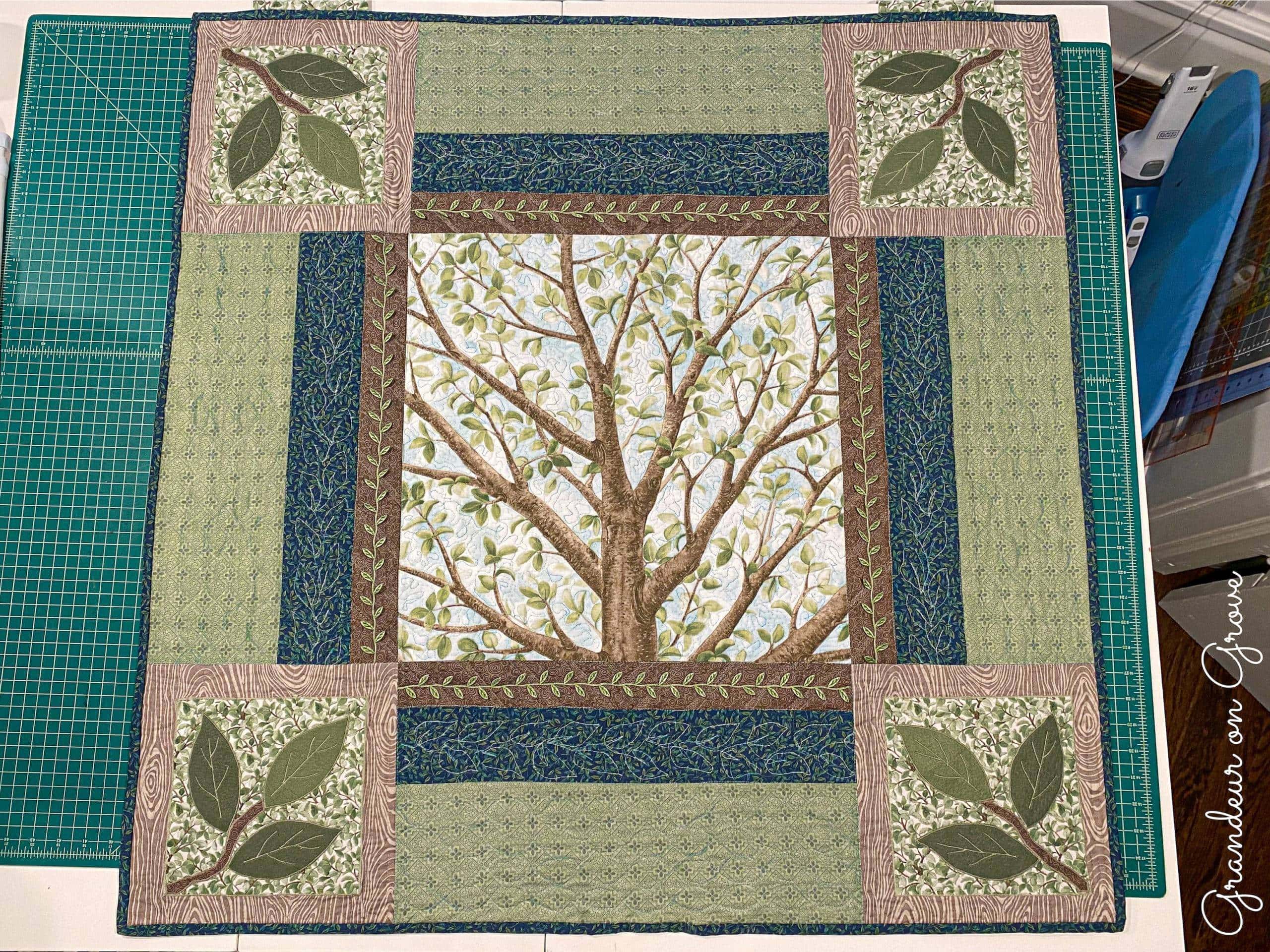 Quilted wall hanging with a tree theme