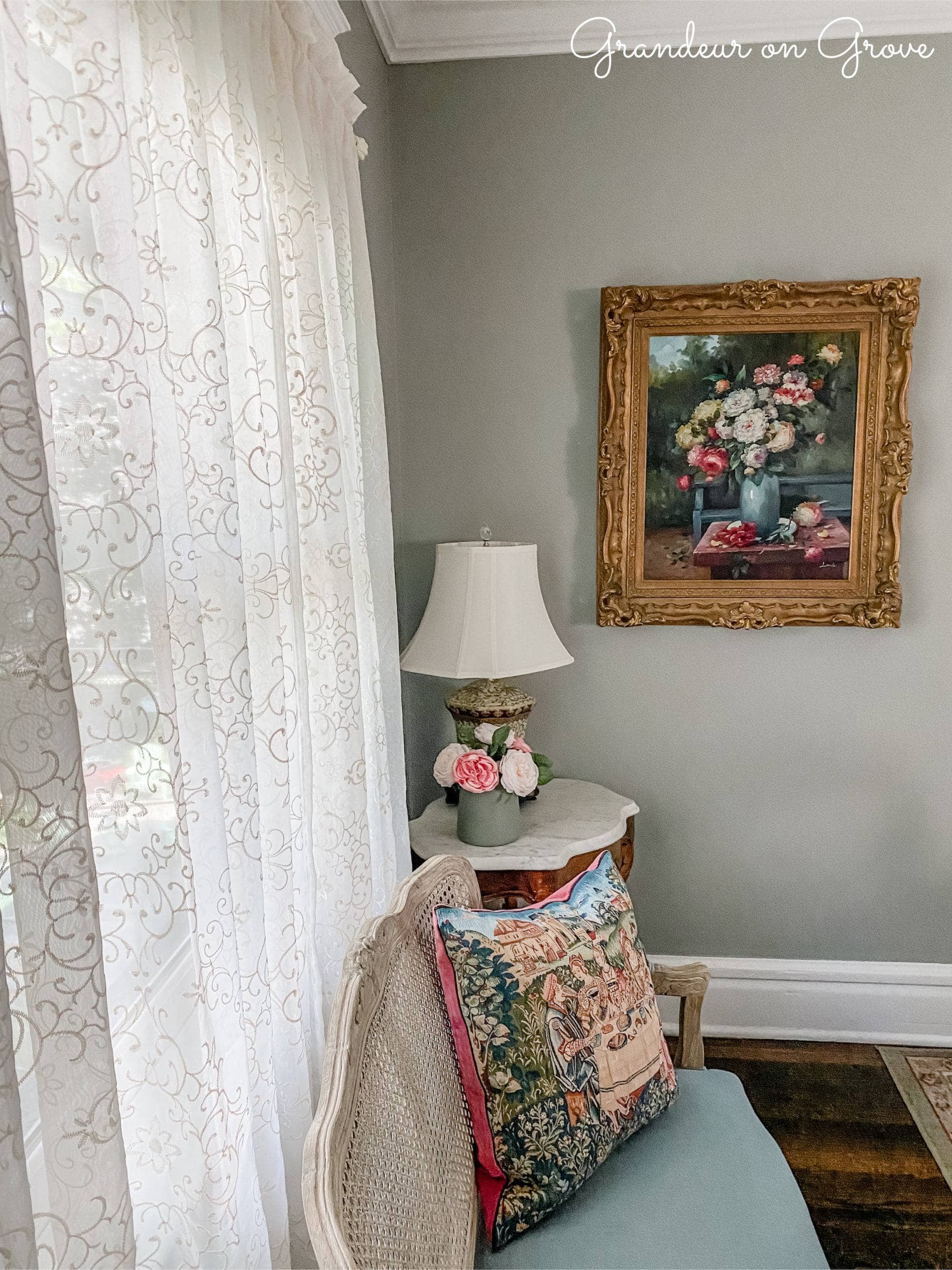 Floral painting and blue bench by window