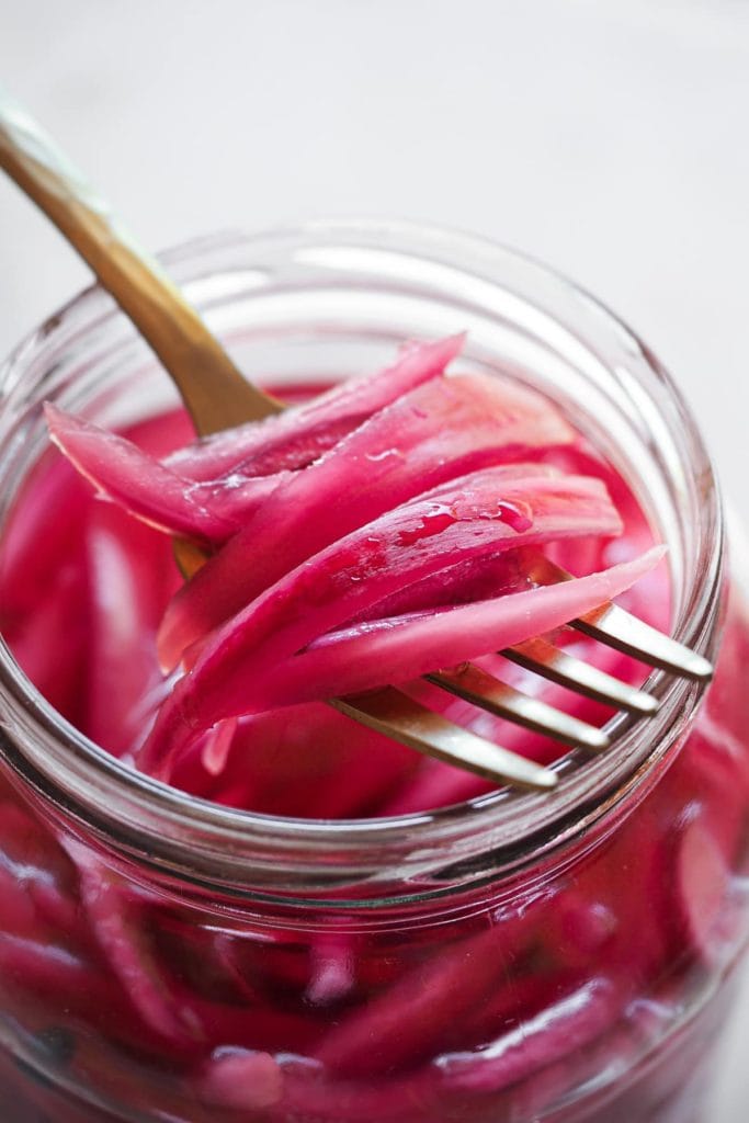 Making Homemade Pickled Onions couldn't be easier or quicker. And what do you get? A tangy, slightly sweet, and punchy onion made with just a handful of ingredients and a little bit of patience (some resting time is needed). It's a kitchen staple that you must include in your repertoire cause it's a super versatile flavour and colour booster. I'm sure that if you make this easy homemade pickled red onion once, you'll come back for more! | Paula's Apron Recipe